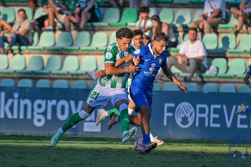 A Xerez CD player battles for the ball with a Betis Deportivo defender