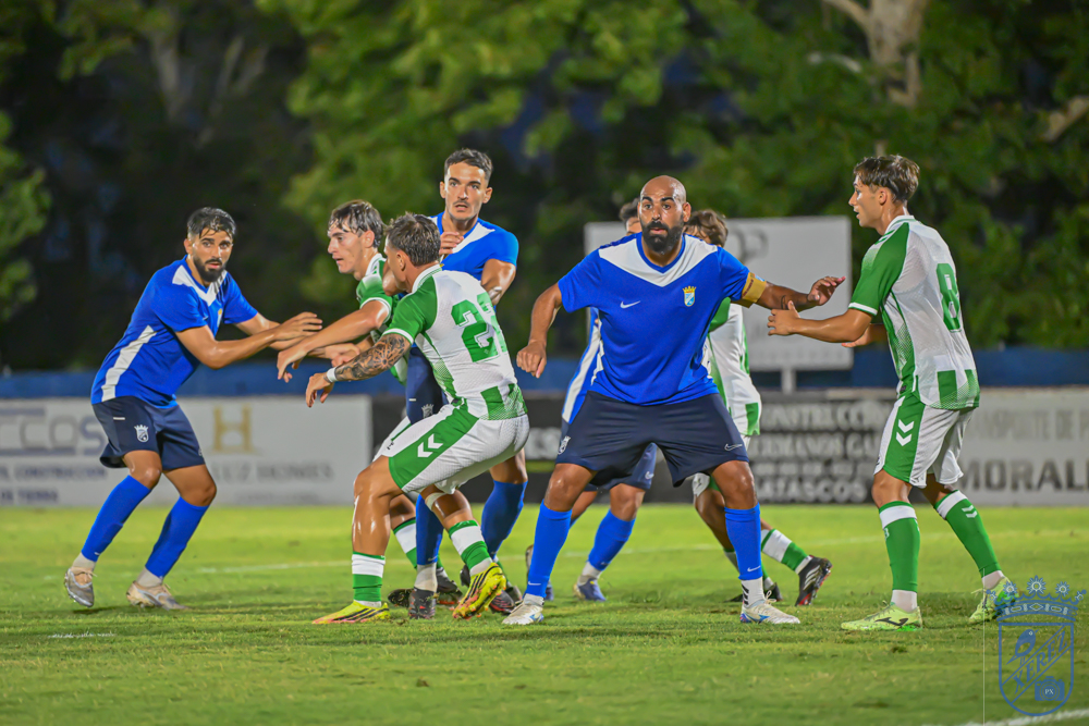Xerez CD and Real Betis C players contest the ball inside the area