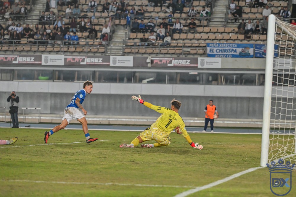 A Xerez CD player shoots as Marbella goalkeeper Bloch comes out