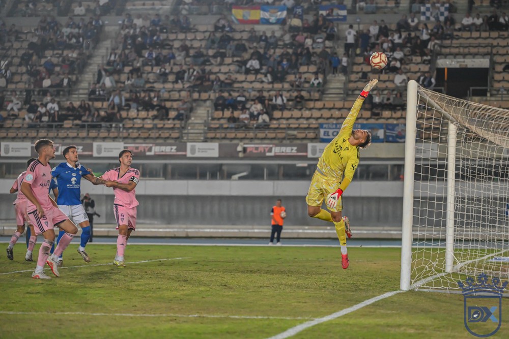 Marbella goalkeeper Bloch stretches to tip the ball away at Chapín